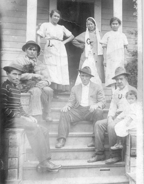 The families of E. 25th Street, Oakland, gather on the porch